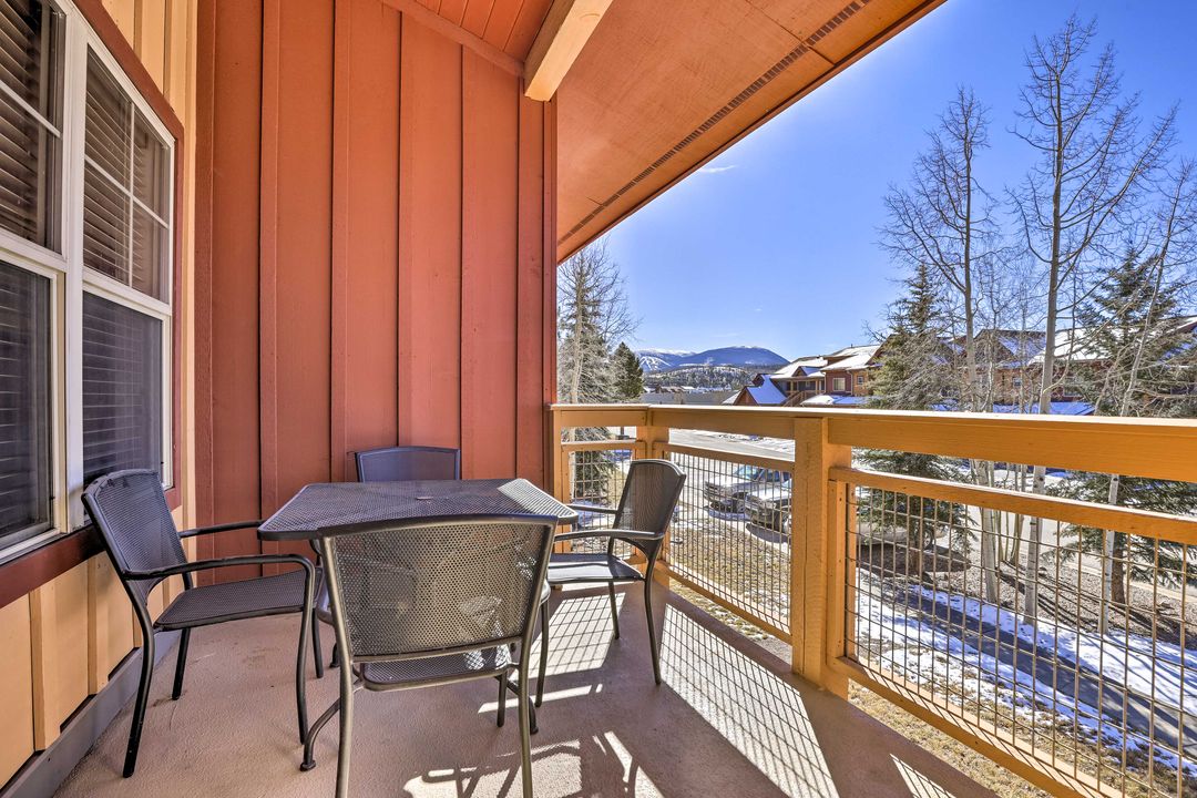 Covered deck with table and mountain view at the Fraser Colorado condo