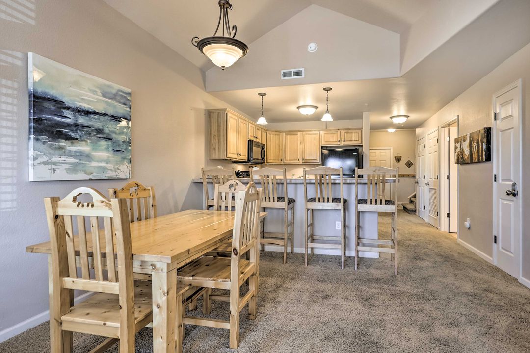 Pine dining table and kitchen bar seating in the Fraser condo near Winter Park