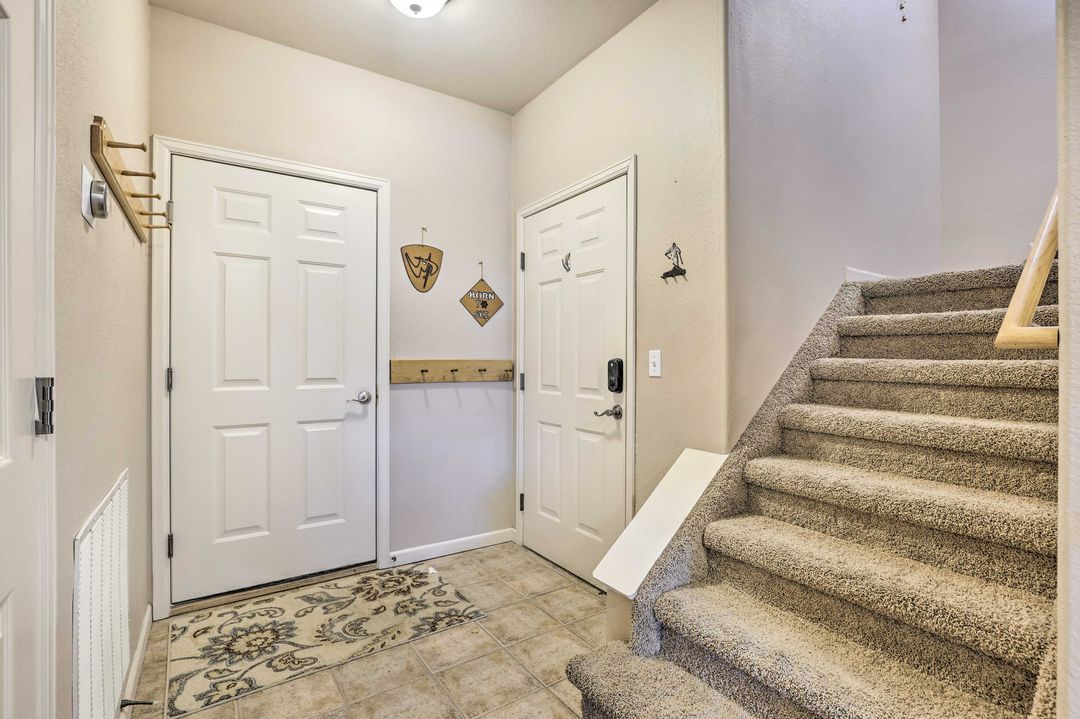 Entry with keyless lock and stairs to an upstairs bedroom suite